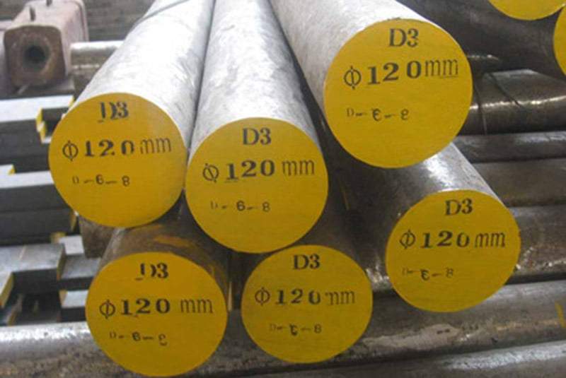 Warehouse stock of round steel bars with green-painted ends