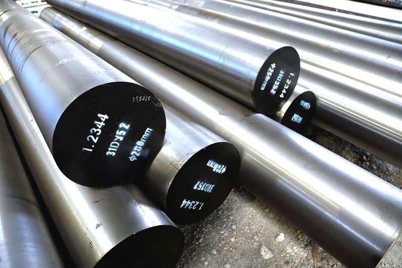 Stacked steel round bars with rough mill surfaces and marked ends