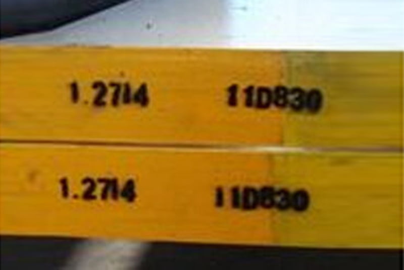 Yellow identification plate or tag photographed close up