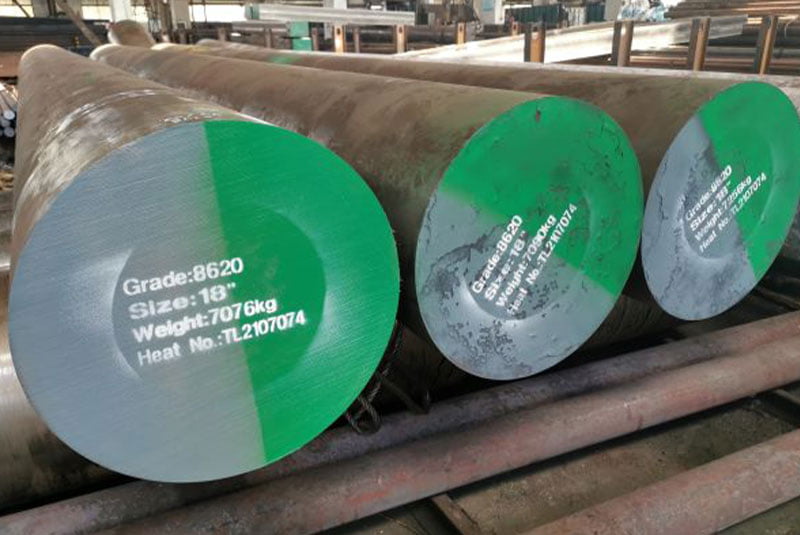 Bundle of dark steel round bars with colour-coded ends
