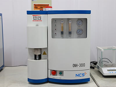 Laboratory analyzer with pressure gauges and sealed chamber.